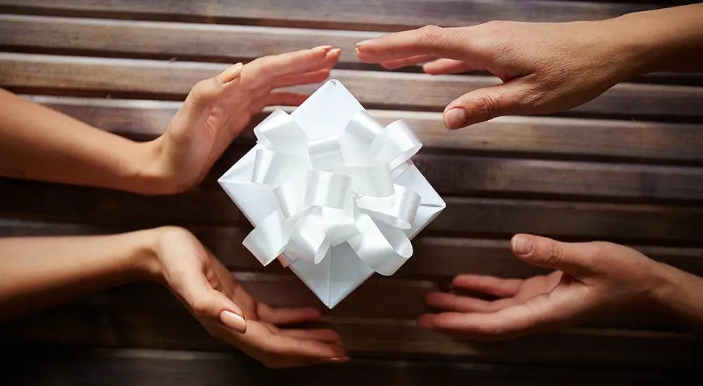 A pristine white satin bow intricately tied as a decorative element for fair trade rainforest protection gifts