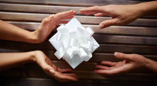 A pristine white satin bow intricately tied as a decorative element for fair trade rainforest protection gifts