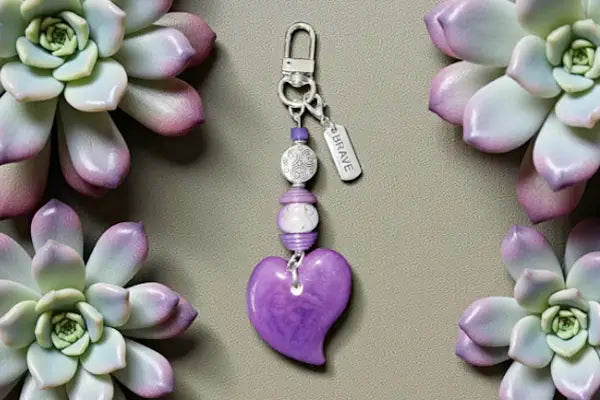 Purple heart-shaped charm with silver clasp and beads featuring an engraved brace tag from our heart collection