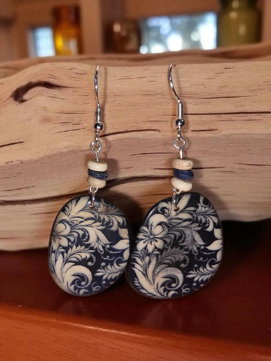 Navy blue and cream floral-patterned oval tagua earrings with wooden beads and silver hooks from a favorite collection