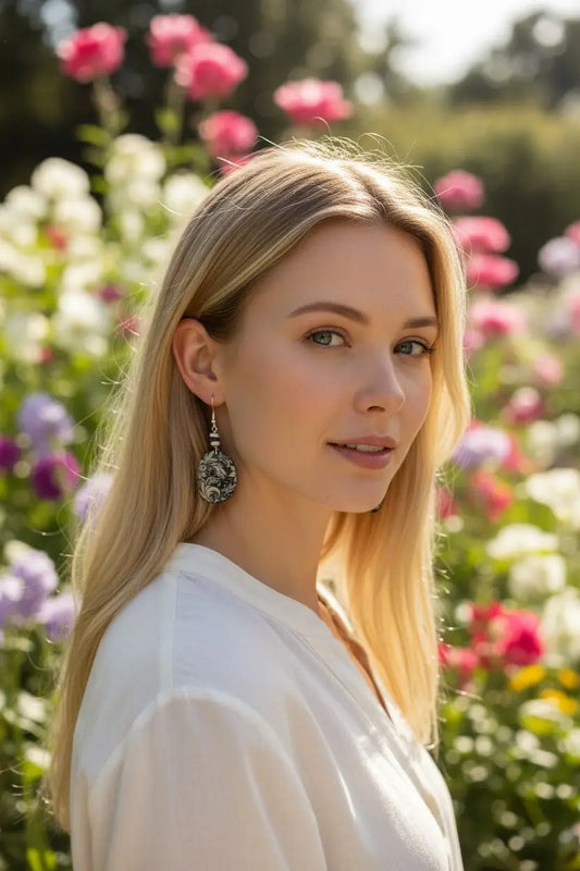 Silver filigree drop earrings with intricate floral detailing featured in blue floral lace engraved tagua earrings product