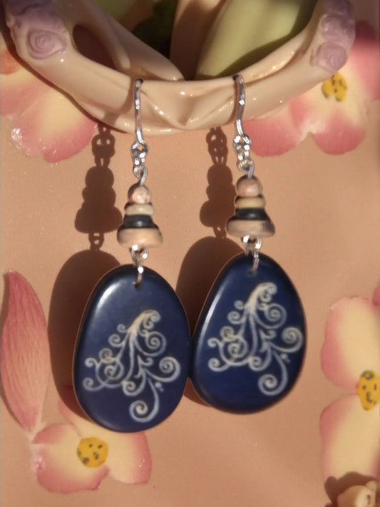 Deep blue teardrop tagua slice dangle earrings with white swirls silver hooks and stacked wooden beads ocean waves design