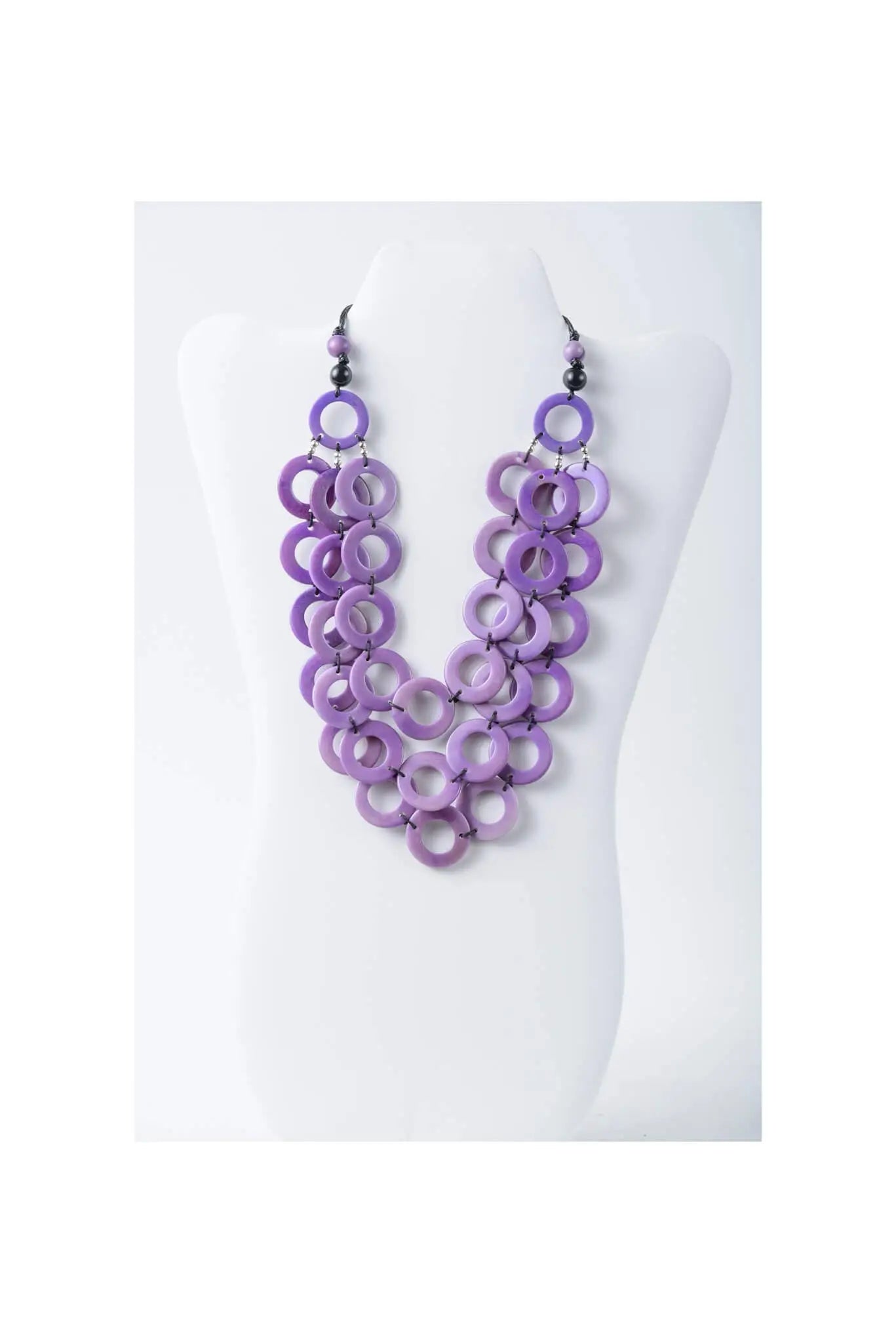 Purple layered circle tagua necklace featuring wooden beads with black accents in pink from Aquilia collection