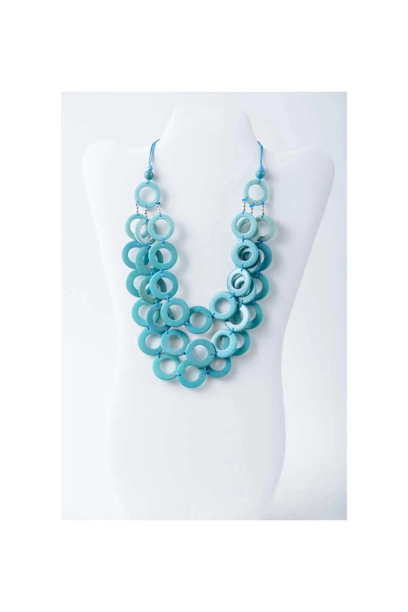 Aquilia layered circle tagua necklace with stacked turquoise wooden beads in gradient shades from light to dark pink