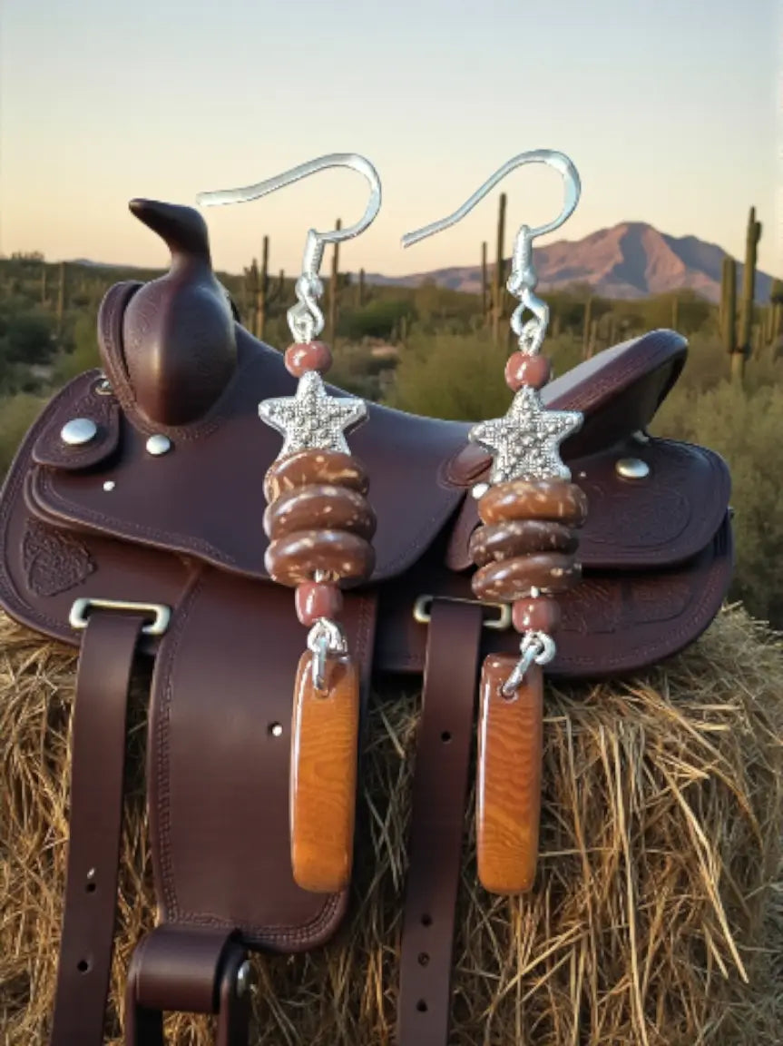 A pair of bay horse brown baguette tagua earrings with silver star charms, wooden beads, and amber wood slices