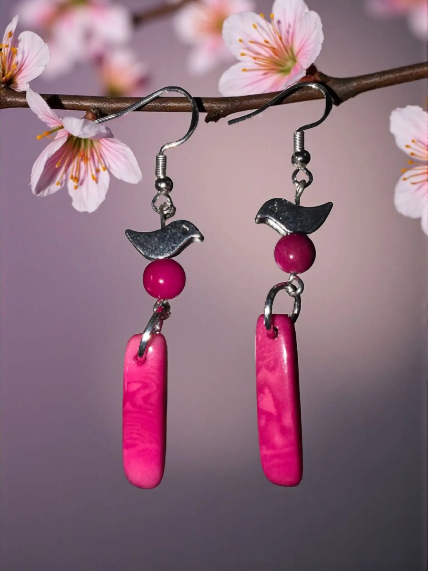Pink bird-shaped tagua earrings with silver coated brass hooks and vibrant fuchsia rectangular pendants handcrafted