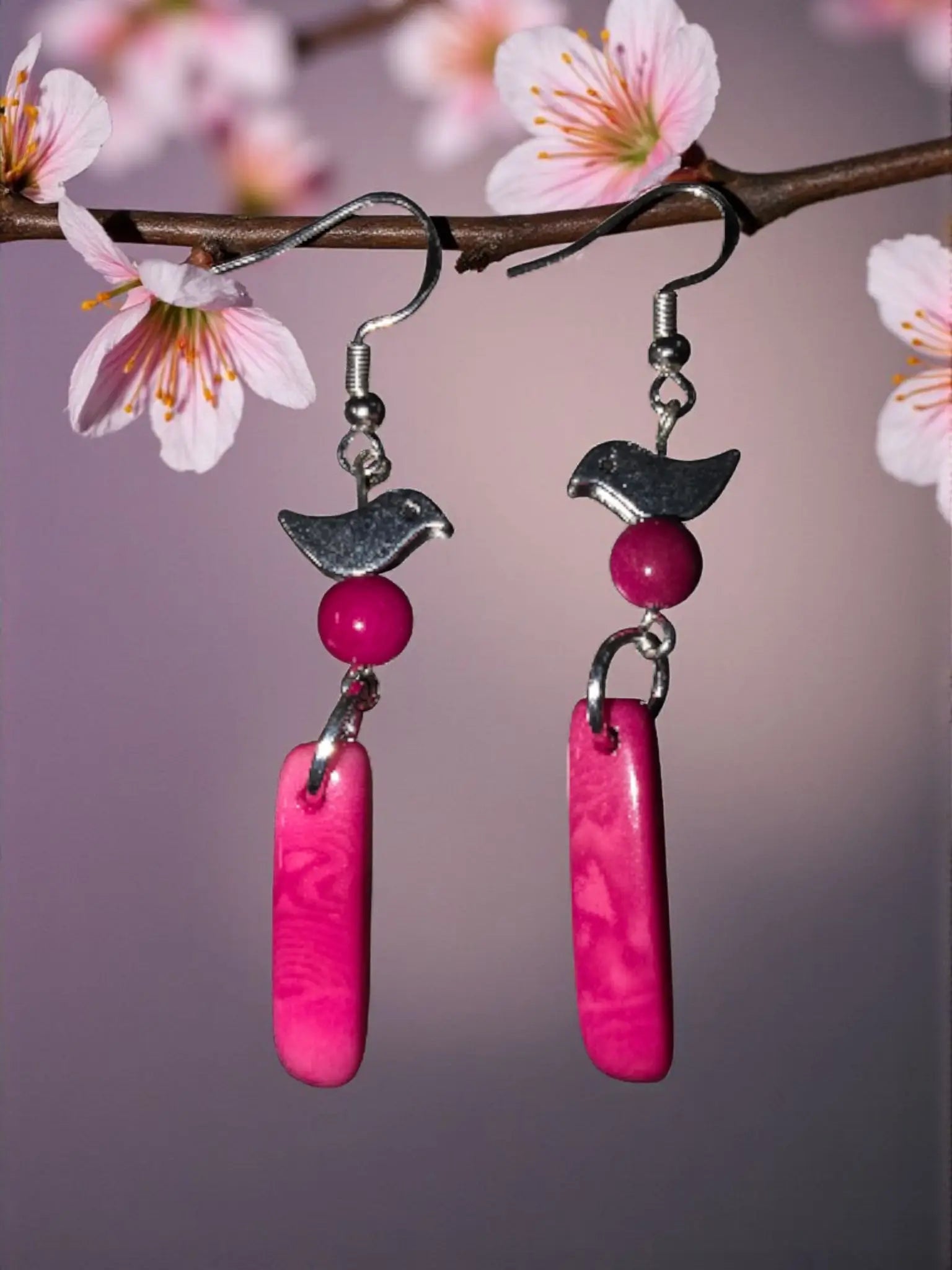 Pink bird-shaped tagua earrings with silver coated brass hooks and vibrant fuchsia rectangular pendants handcrafted