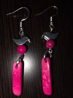 A pair of handmade be pretty in pink tagua earrings with silver coated brass bird charms and marbled pink beads