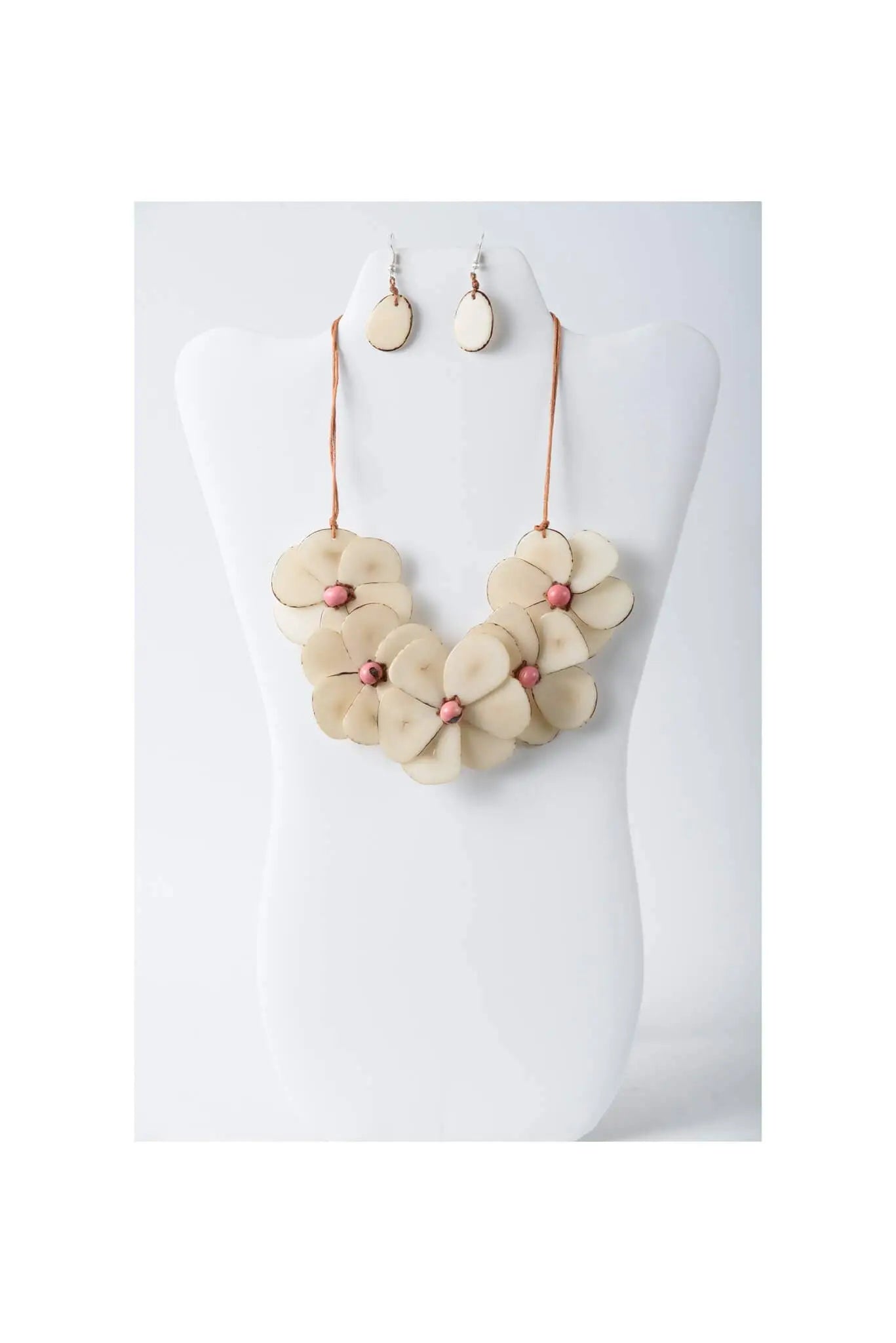 Beige flower bib necklace with layered petal design and rose-gold accents on white mannequin by becca handcrafted tagua set