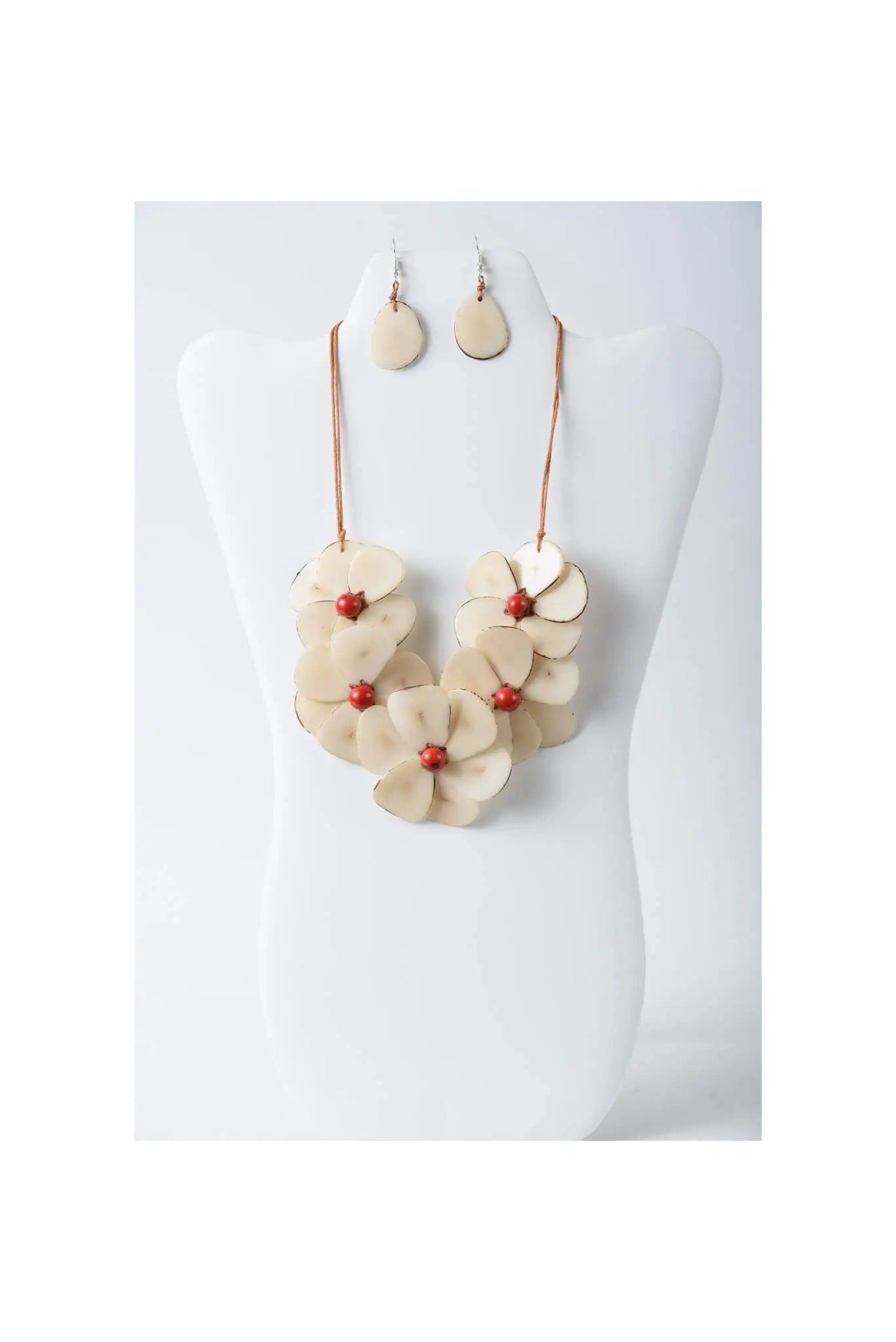 Cream-colored flower bib necklace set with layered petal tagua design and red bead centers with matching earrings