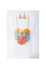 Vibrant becca handmade flower bib tagua necklace with peach orange blue petals and yellow centers in a floral design