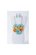 Vibrant turquoise and orange flower bib necklace set with matching earrings made from layered resin petals by becca handcrafted