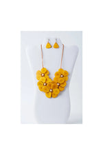 Vibrant yellow flower bib necklace set with layered petal design and matching tagua earrings by becca handmade