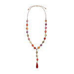 A becky necklace featuring vibrant bombona seeds and tagua nut beads with earthy tones and a red teardrop pendant