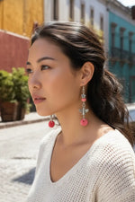 Pink tagua nut bee earrings with flower bead accent and silver-toned metal details