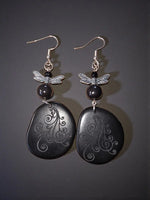 Black ghost swirl laser engraved lightweight tagua slice earrings with black stone and silver dragonfly charms