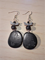 Black stone dragonfly earrings with silver filigree wings and laser engraved swirl patterns lightweight tagua slice