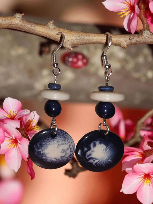 Blue dreamy nights dark blue circular disc earrings with swirling white patterns and silver hook closure