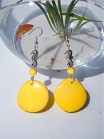 Bright yellow tagua nut slice earrings with teardrop shape silver seahorse charms and matching beads