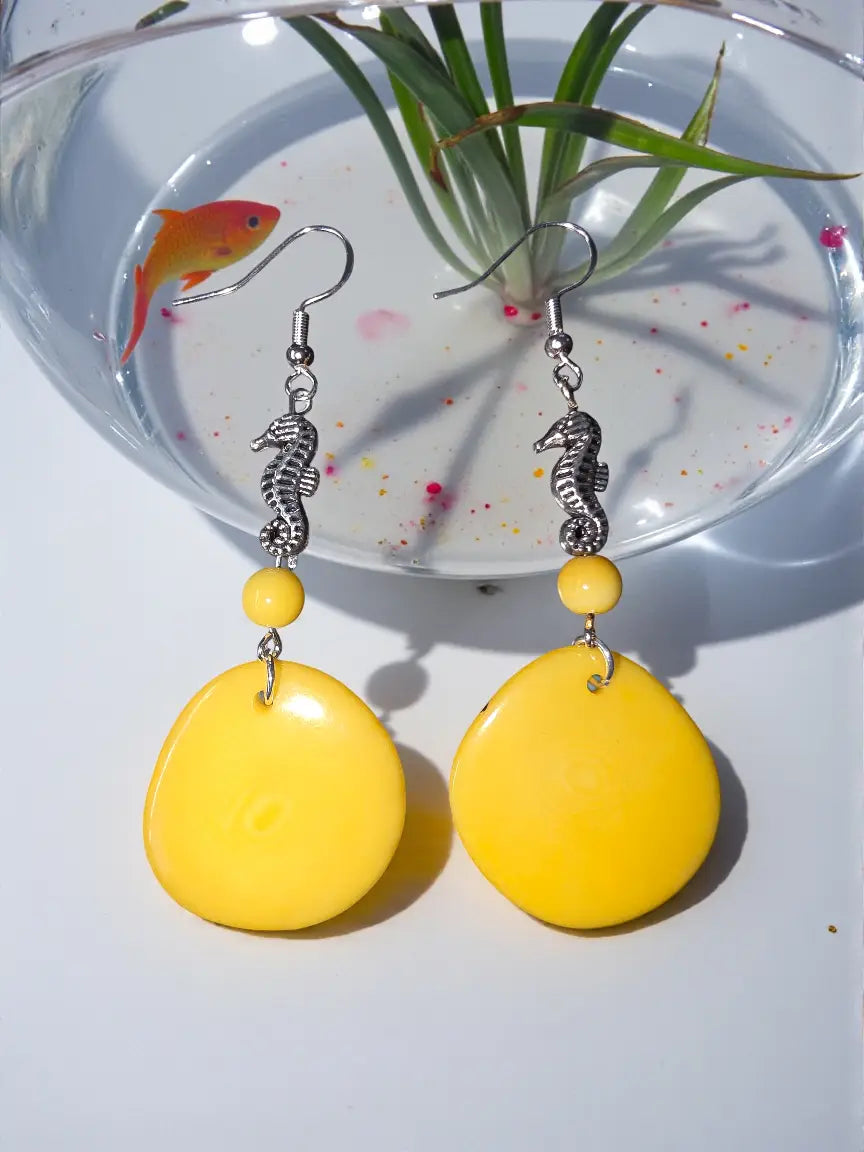 Bright yellow tagua nut slice earrings with teardrop shape silver seahorse charms and matching beads