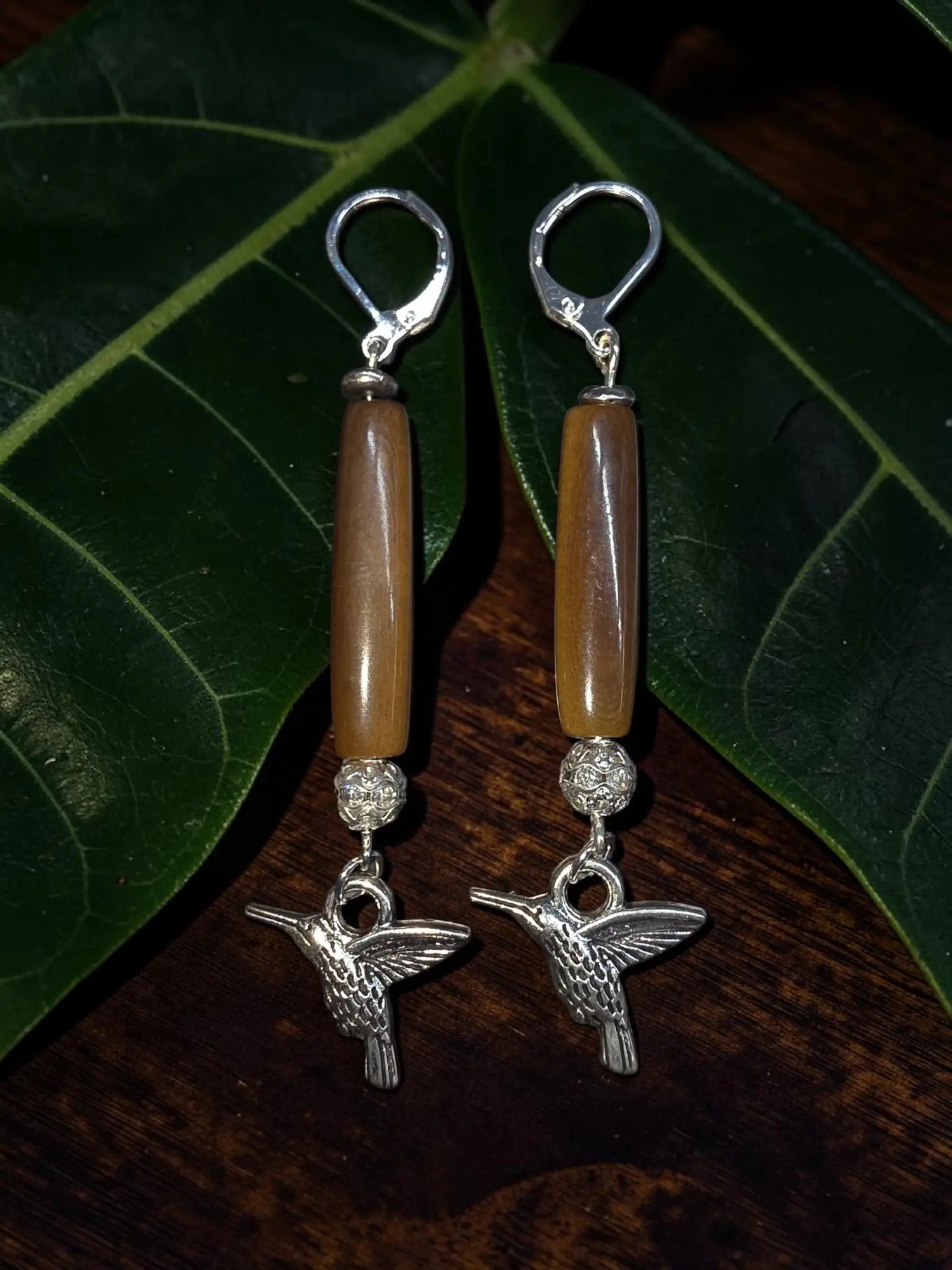 Brown polished tagua carved vegetable ivory earrings with silver hummingbird dangles amber beads and sparkling accents