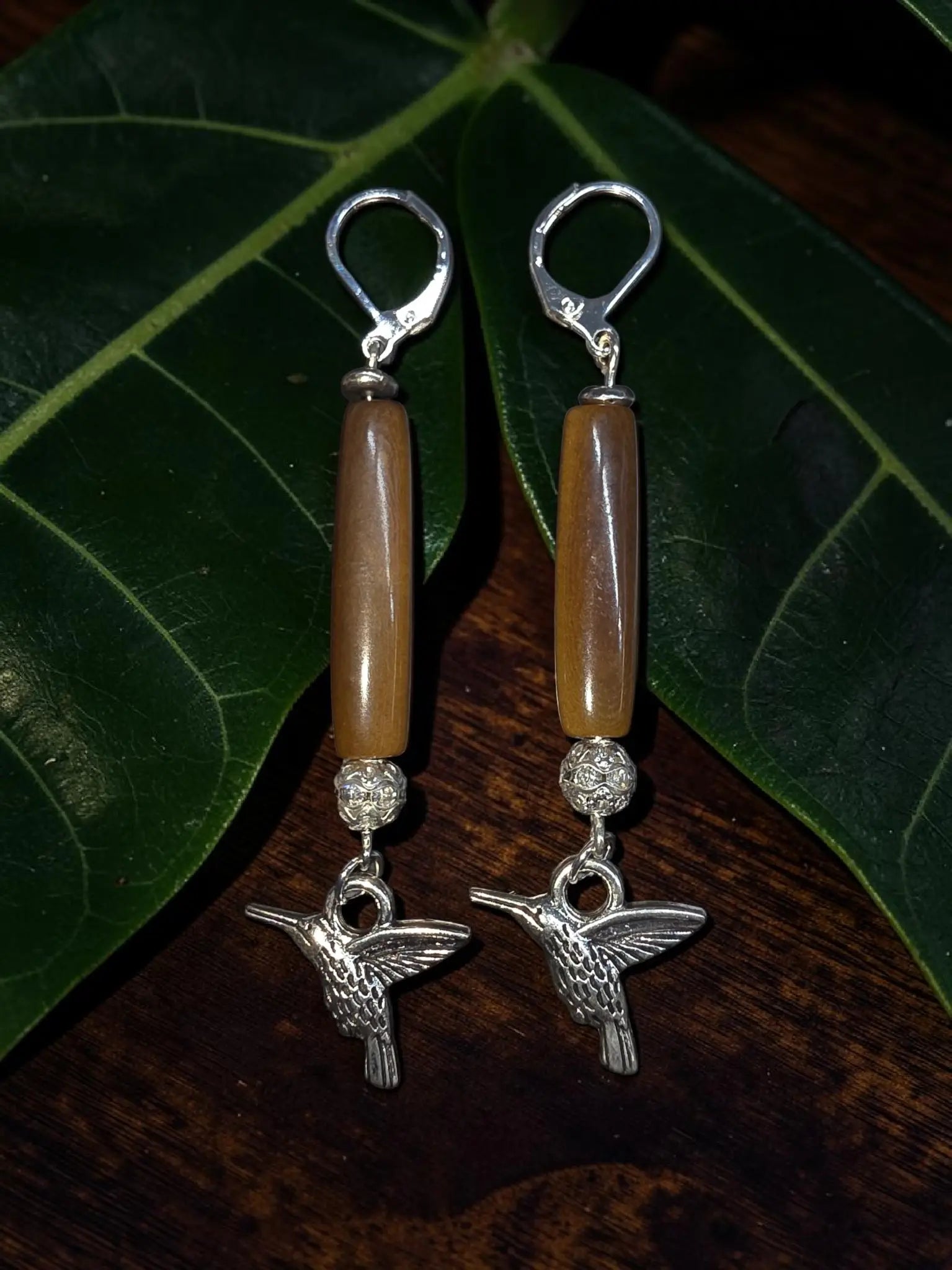 Brown polished tagua carved vegetable ivory earrings with silver hummingbird dangles amber beads and sparkling accents