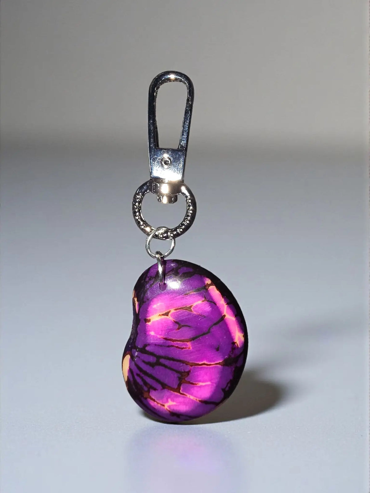 Burgundy key chain bag charm with purple and pink marbled resin and silver toned metal clasp