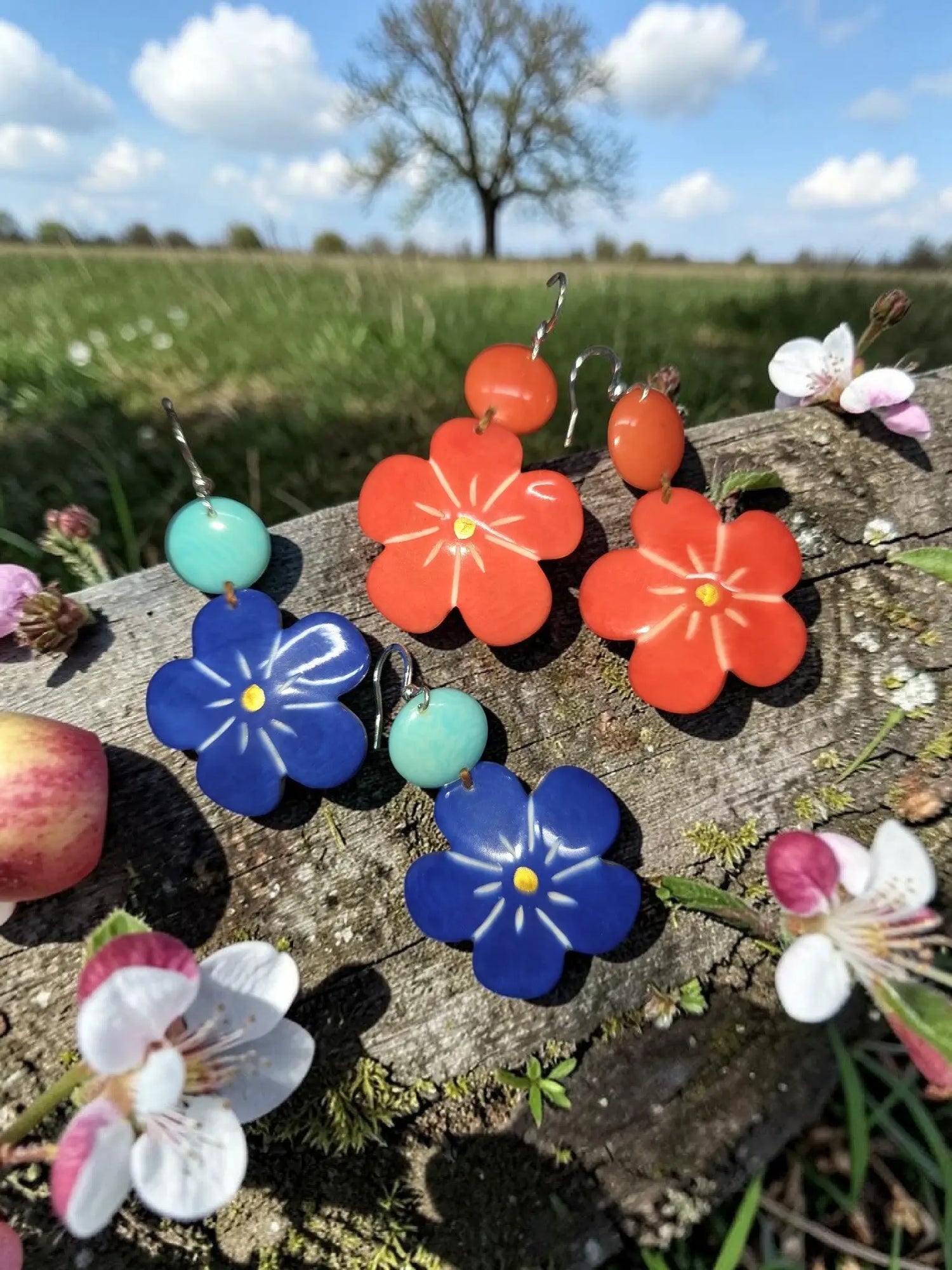 Vibrant red and blue carved flower stephanie earrings made from sustainable tagua nut resin with yellow centers