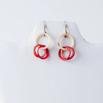 Catalina circular tagua earrings with cream top ring and three overlapping red circles on silver fishhook clasps
