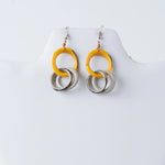 Yellow and silver circular tagua ring earrings with a modern layered design perfect for stylish looks