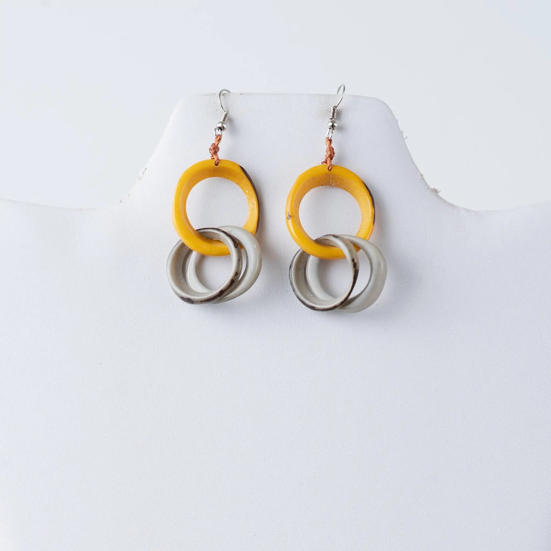 Yellow and silver circular tagua ring earrings with a modern layered design perfect for stylish looks