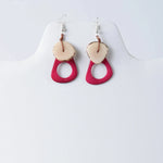 Charli geometric tagua earrings are vibrant fuchsia and cream resin drops with natural wood edge detail