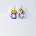 Purple and yellow layered Charli geometric tagua earrings with rustic brown cord detail for stylish wear