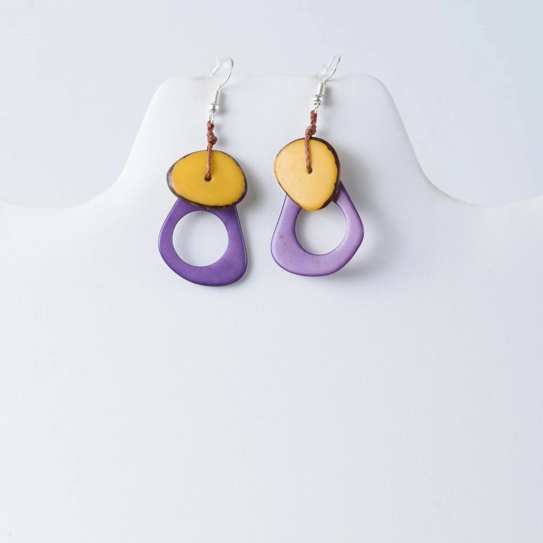 Purple and yellow layered Charli geometric tagua earrings with rustic brown cord detail for stylish wear
