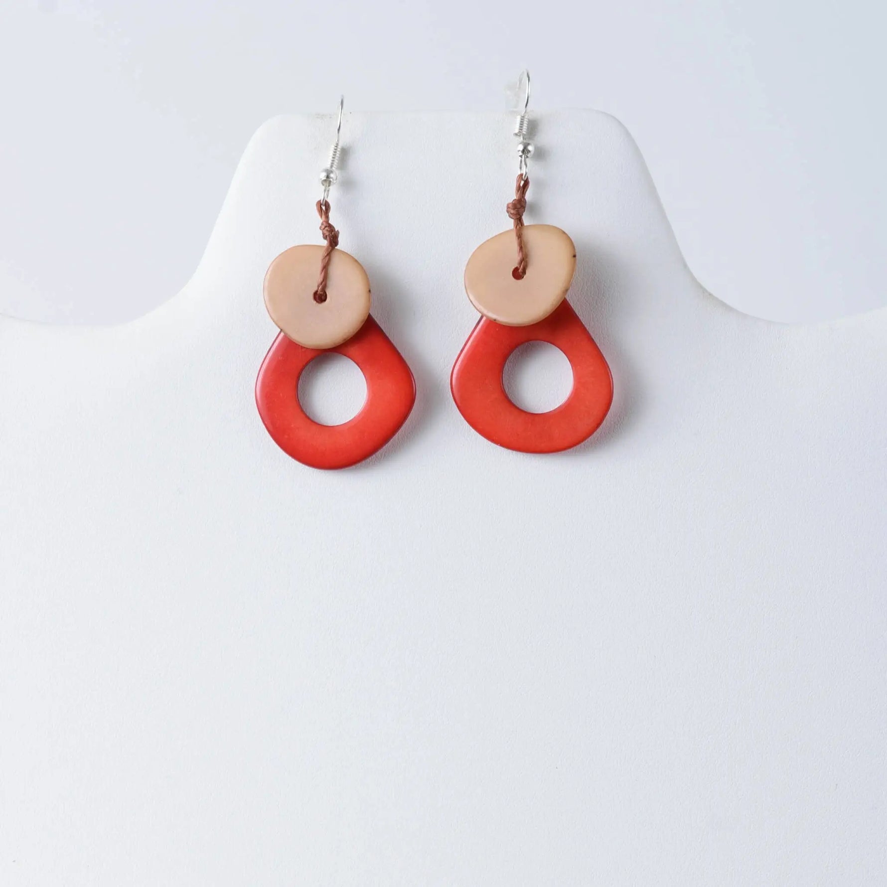 Charli geometric tagua earrings with vibrant red and beige layered drop design and rustic handcrafted style