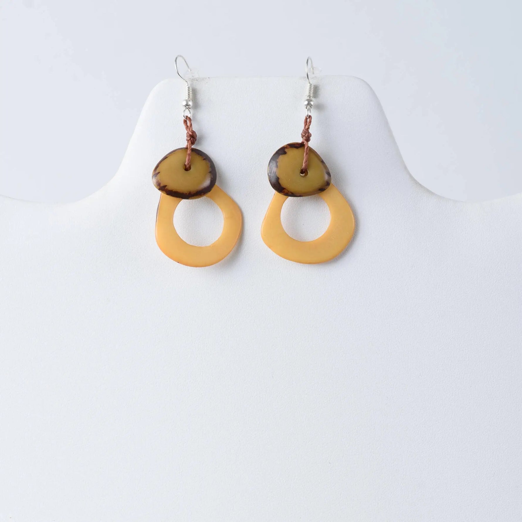 Yellow and brown circular shell earrings with a natural organic design from charli geometric tagua earrings collection