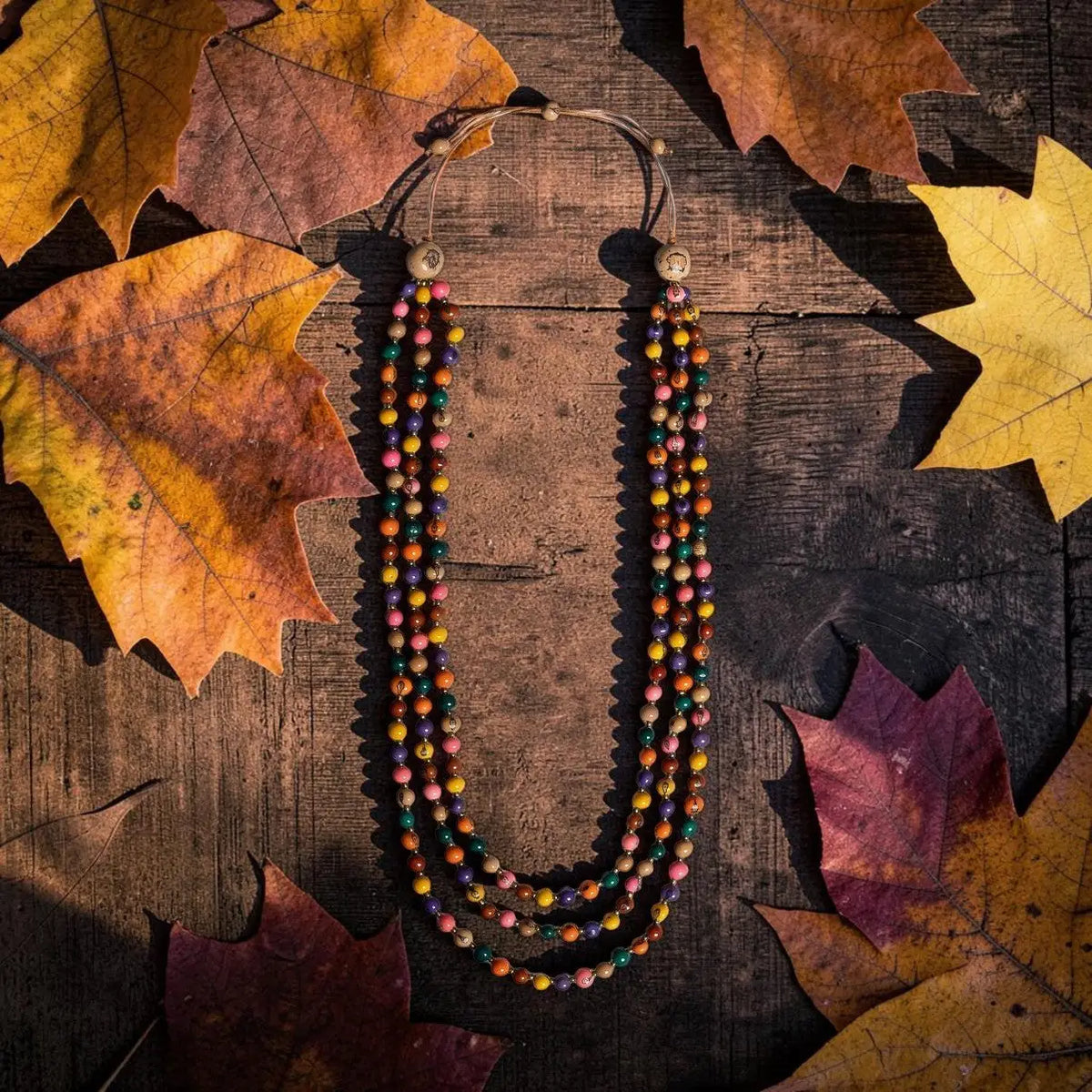 Cheryl necklace multi-strand tagua nut necklace with colorful earthy beads on natural cord and wooden toggle clasps