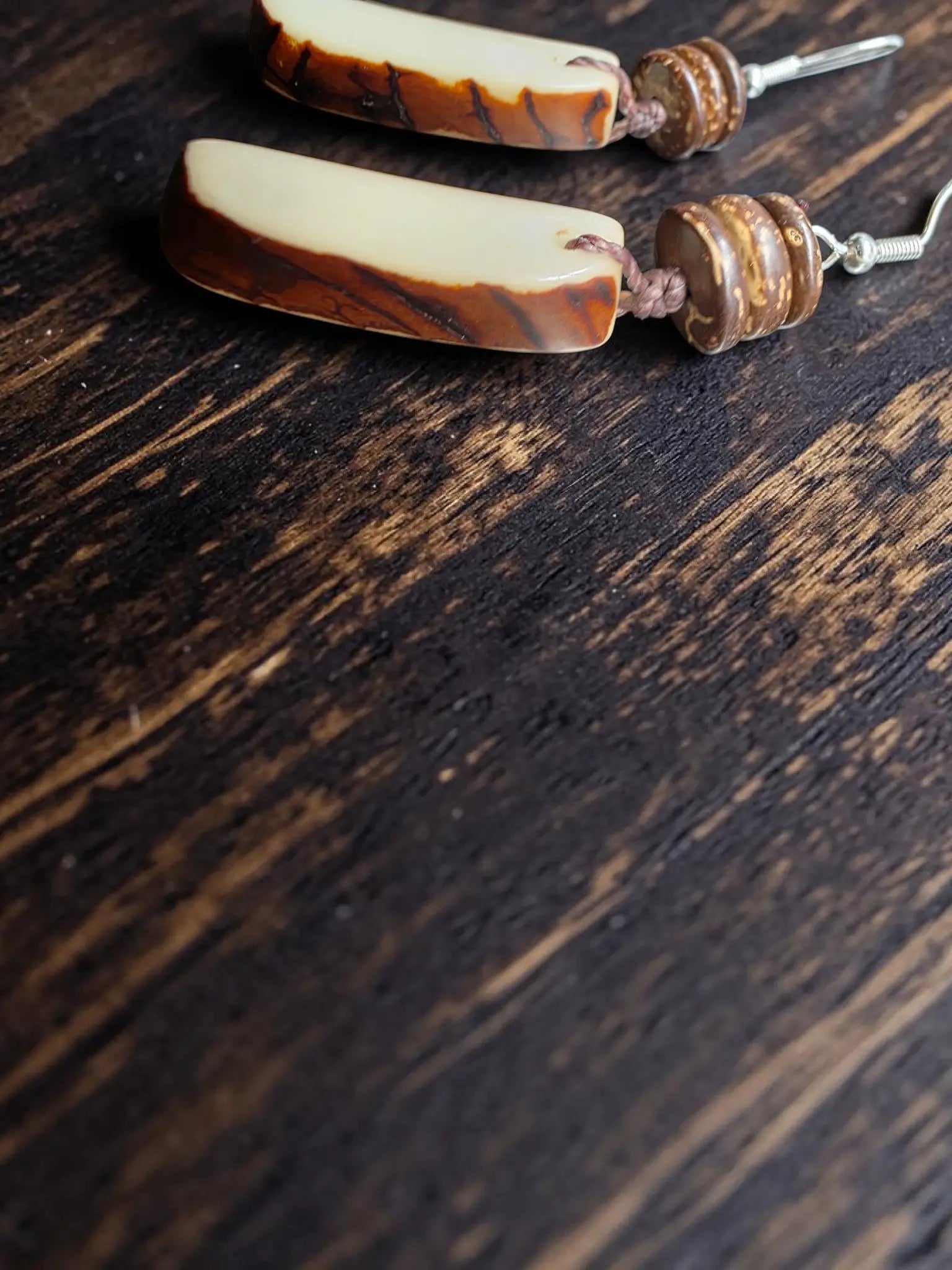 Cream raw edge tagua carved vegetable ivory earrings with creamy beige and brown stripes and forest seeds detail