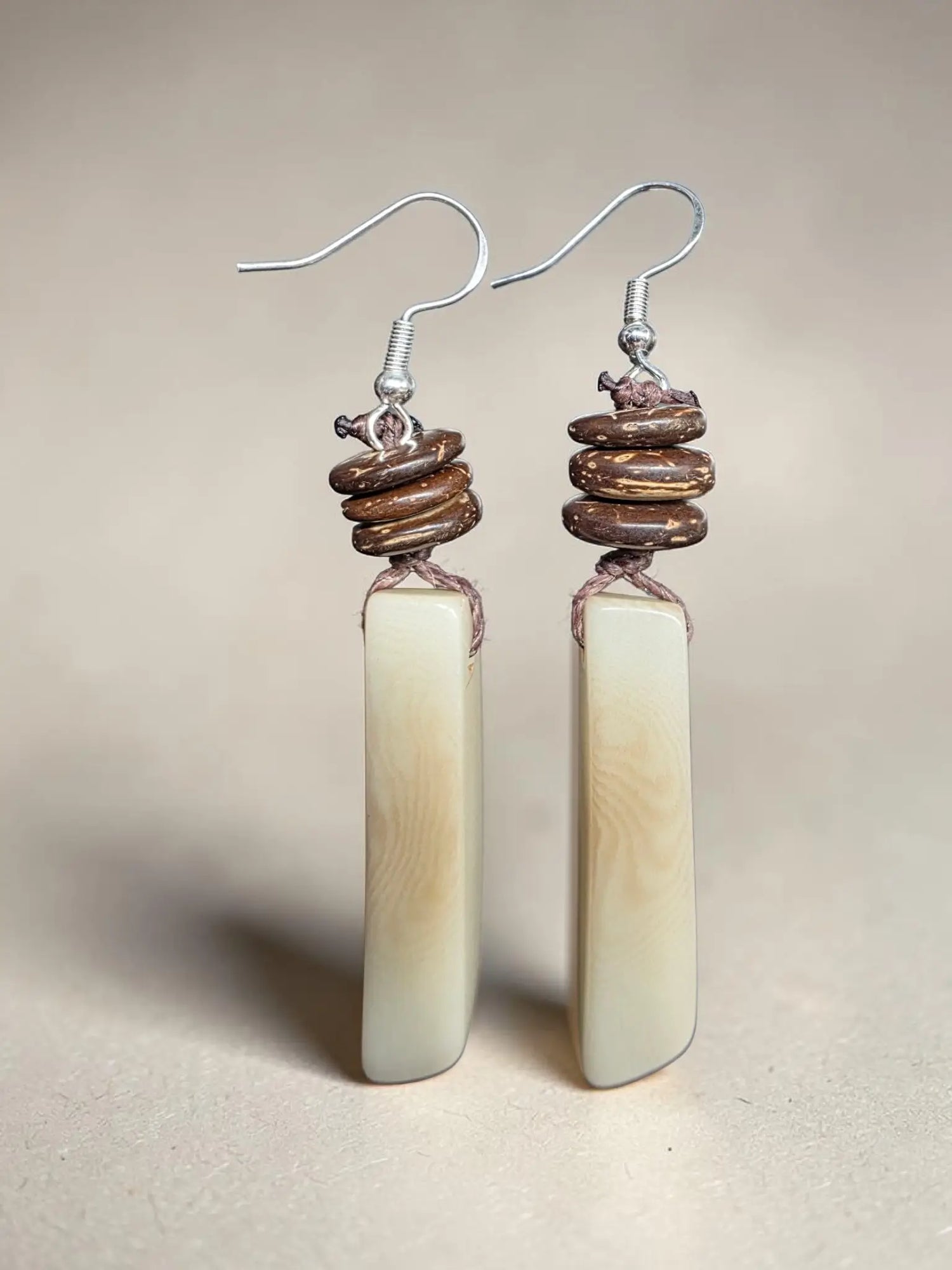 Elegant cream raw edge tagua vegetable ivory earrings with polished jadeite and forest seeds in silver hooks