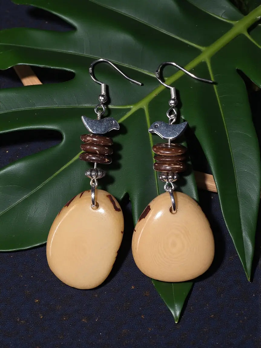 Cream sliced tagua nut earrings with beige teardrop shape dark brown bird bead and silver bird charms
