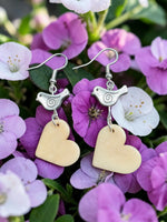 Silver bird earrings with heart-shaped beige carved vegetable ivory pendants from rainforest cream tagua collection