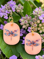 Peach-colored eleni earrings with painted dragonfly tagua nut design and gold-toned hooks for a cute look