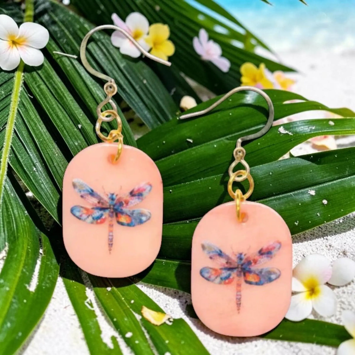 Peach-colored eleni earrings with multicolored dragonfly tagua nut design and gold-toned hooks and chain details