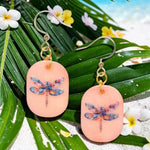 Peach-colored eleni earrings with multicolored dragonfly tagua nut design and gold-toned hooks and chain details