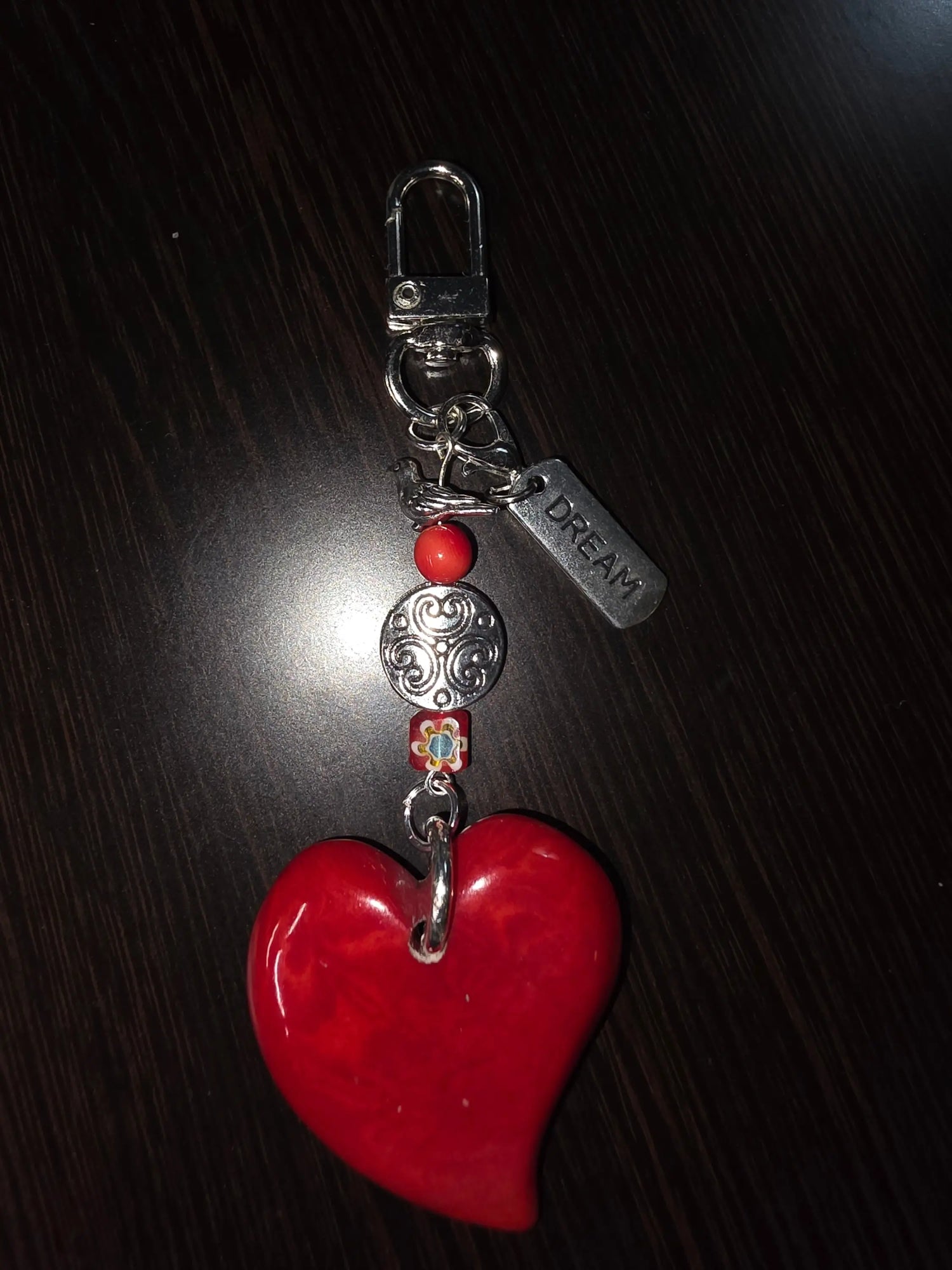Glossy red ceramic heart keychain with silver-toned clasp decorative beads and engraved dream tag bag charm