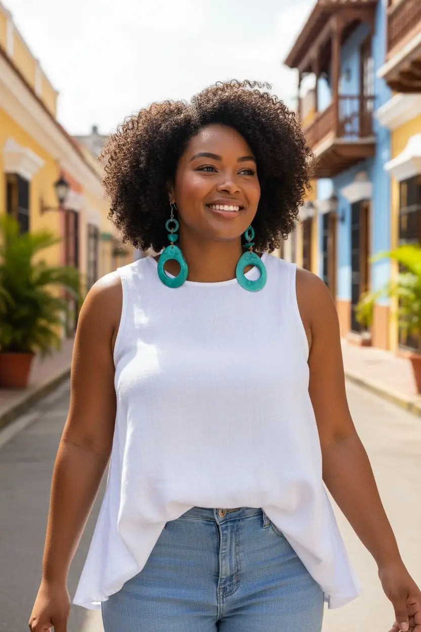 White sleeveless top with flowing asymmetrical hemline and dreamy ocean turquoise tagua hoop slice earrings