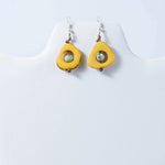 Eden teardrop eco-friendly earrings with bright yellow tagua, light green bead, and brown accents