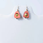 Coral-colored eden tear-drop eco-friendly tagua earrings with yellow bead and gold-toned accents