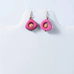 Eden tear drop eco friendly tagua earrings with vibrant pink teardrop shape, peach bead, and gold toned accents