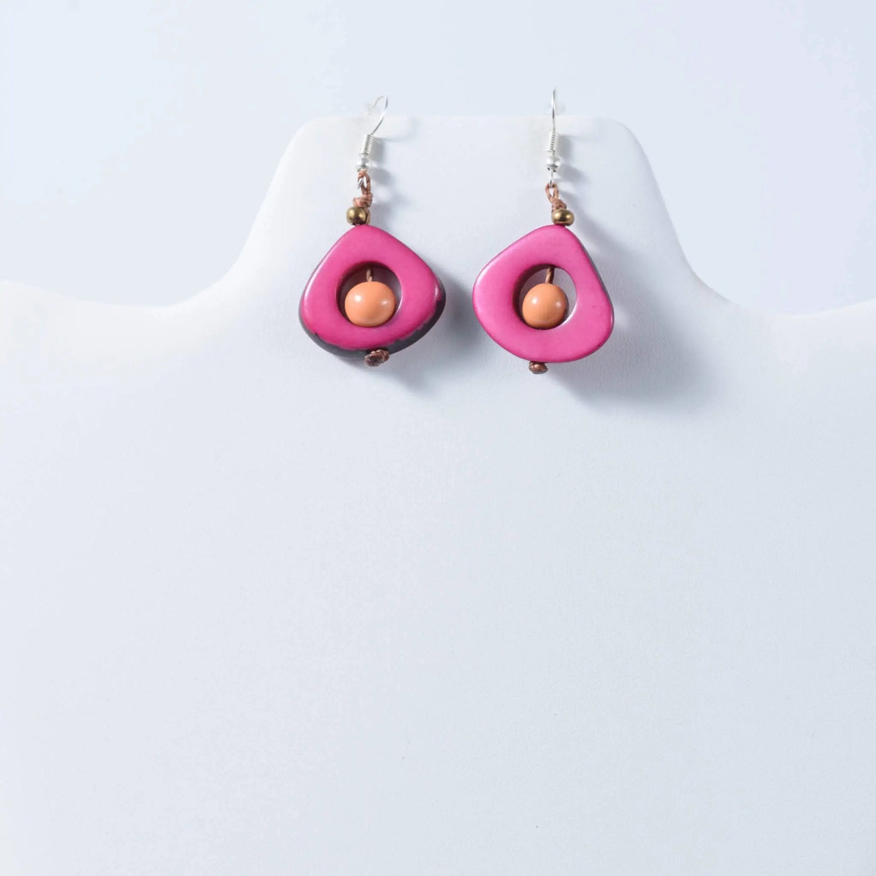 Eden tear drop eco friendly tagua earrings with vibrant pink teardrop shape, peach bead, and gold toned accents